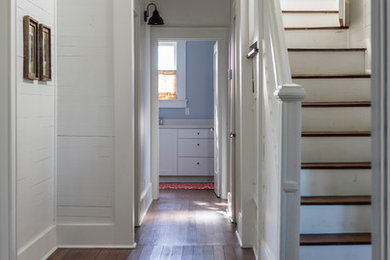 Inspiration for a mid-sized country wood straight staircase in Austin with painted wood risers and wood railing.