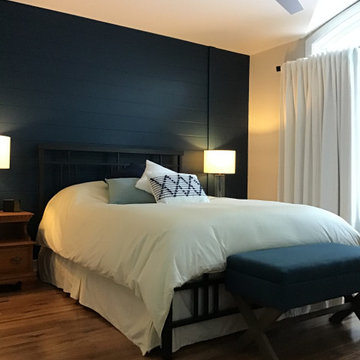 Blue shiplap wall is the star in this master bedroom