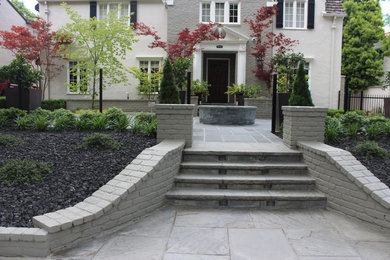 Inspiration for a large traditional front yard stone formal garden in Sacramento.