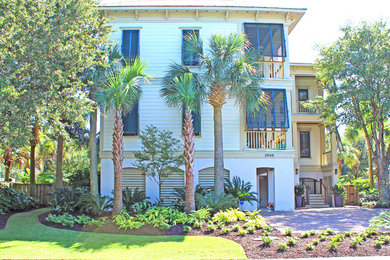 Mid-sized beach style yellow three-story mixed siding exterior home photo in Charleston