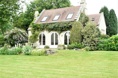 Foto de fachada de casa blanca tradicional renovada de tamaño medio de dos plantas con tejado a cuatro aguas y tejado de teja de barro