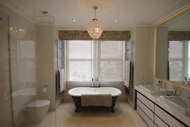 This is an example of a large eclectic master bathroom in Sussex with flat-panel cabinets, white cabinets, a freestanding tub, an open shower, a one-piece toilet, grey walls, porcelain floors, a drop-in sink, solid surface benchtops, beige floor, a hinged shower door and white benchtops.
