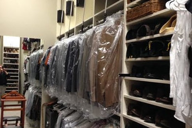 This is an example of a large classic walk-in wardrobe for men in Dallas with open cabinets, white cabinets and carpet.