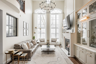 Example of a transitional open concept dark wood floor and brown floor living room design in Montreal with beige walls, a standard fireplace and a concrete fireplace
