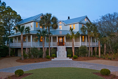 Large tropical white two-story wood exterior home idea in Charleston with a hip roof