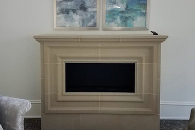 This is an example of a transitional master bedroom in Dallas with a standard fireplace and a concrete fireplace surround.