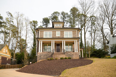 Example of a large classic brown two-story mixed siding house exterior design in Atlanta with a hip roof and a mixed material roof