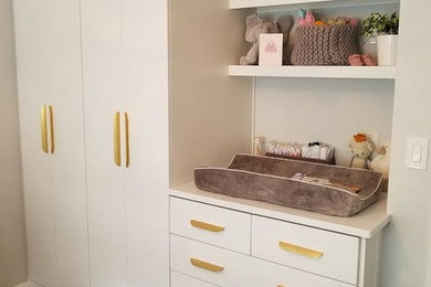 Example of a mid-sized trendy gender-neutral dark wood floor and brown floor nursery design in Seattle with white walls