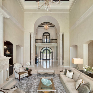 Inspiration for an expansive mediterranean formal open plan living room in Miami with beige walls, marble flooring, a standard fireplace and a stone fireplace surround.