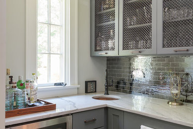 Eat-in kitchen - eclectic dark wood floor eat-in kitchen idea in New York with an undermount sink, shaker cabinets, gray cabinets, marble countertops, metallic backsplash, mirror backsplash and paneled appliances