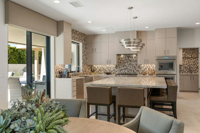 Trendy concrete floor and gray floor kitchen photo in Other with a single-bowl sink, flat-panel cabinets, beige cabinets, quartz countertops, multicolored backsplash, mosaic tile backsplash, stainless steel appliances, an island and white countertops