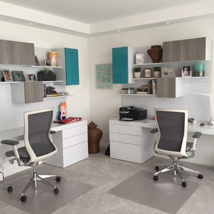 Design ideas for a medium sized modern study in Miami with white walls, carpet, a freestanding desk and white floors.