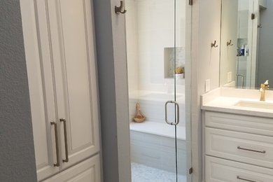 Inspiration for a mid-sized contemporary master ceramic tile and gray floor walk-in shower remodel in Minneapolis with raised-panel cabinets, white cabinets, a one-piece toilet, an undermount sink, quartz countertops and a hinged shower door
