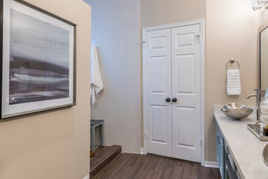 Inspiration for a mid-sized transitional master white tile and porcelain tile porcelain tile doorless shower remodel in Houston with flat-panel cabinets, blue cabinets, a two-piece toilet, beige walls, a vessel sink and quartz countertops