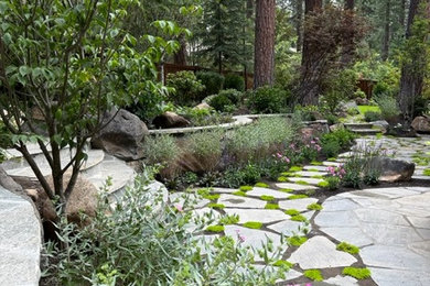 This is an example of a partial sun backyard stone landscaping in Other for summer.