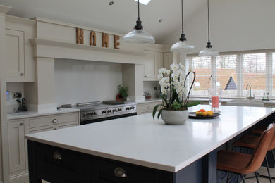 Inspiration for a large farmhouse u-shaped open plan kitchen in Other with a belfast sink, shaker cabinets, quartz worktops, white splashback, stainless steel appliances, an island, beige floors, white worktops and a vaulted ceiling.