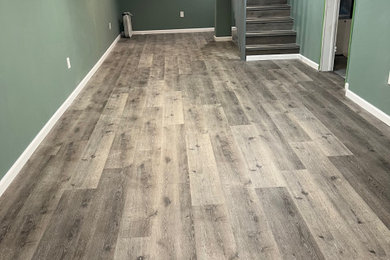 Inspiration for a mid-sized craftsman underground vinyl floor and gray floor basement remodel in Other with gray walls