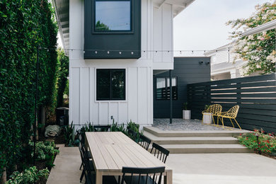 Example of a small backyard concrete patio design in Orange County with no cover