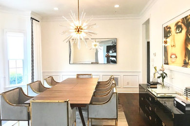Photo of a transitional dining room in New York with white walls, dark hardwood floors and brown floor.