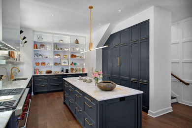 Large transitional u-shaped dark wood floor and brown floor eat-in kitchen photo in Chicago with an undermount sink, recessed-panel cabinets, blue cabinets, marble countertops, white backsplash, marble backsplash, stainless steel appliances, an island and white countertops