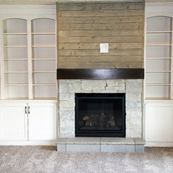 Fireplace in living room with wood mantel shelf and built-in white shelving - Products