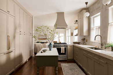 Eat-in kitchen - mid-sized craftsman galley dark wood floor and brown floor eat-in kitchen idea with a single-bowl sink, shaker cabinets, beige cabinets, quartz countertops, beige backsplash, porcelain backsplash, paneled appliances, an island and white countertops