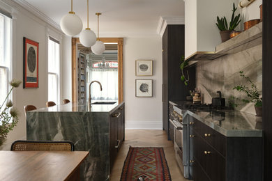 Mid-sized transitional galley light wood floor and beige floor eat-in kitchen photo in Toronto with an undermount sink, flat-panel cabinets, dark wood cabinets, solid surface countertops, green backsplash, stone slab backsplash, stainless steel appliances, an island and green countertops