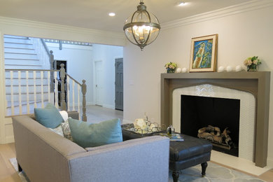 Inspiration for a timeless light wood floor and gray floor living room remodel in Other with white walls, a standard fireplace and a tile fireplace