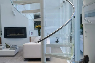 Small minimalist glass spiral glass railing and wall paneling staircase photo in San Francisco
