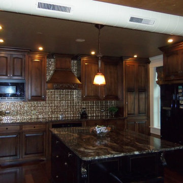 Kitchen granite countertops, tin backsplash, custom cabinets, exposed air vent