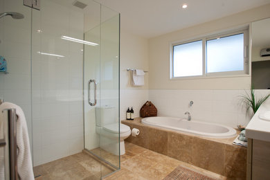 Photo of a mid-sized contemporary master bathroom in Christchurch with beige cabinets, beige tile, beige walls and ceramic floors.