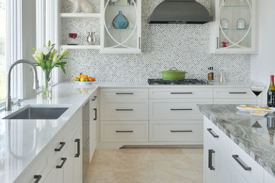 Mid-sized transitional u-shaped orange floor eat-in kitchen photo in Atlanta with an undermount sink, flat-panel cabinets, white cabinets, multicolored backsplash, mosaic tile backsplash, stainless steel appliances, an island and white countertops