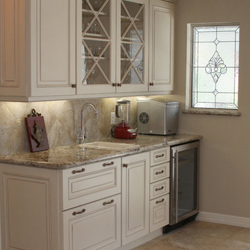 Traditional white wet bar with "x" style glass cabinet doors