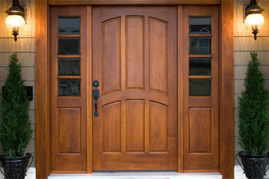 Design ideas for a mid-sized front door in Cincinnati with beige walls, carpet, a single front door and a medium wood front door.
