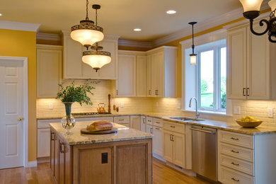 Inspiration for a large timeless u-shaped light wood floor and beige floor open concept kitchen remodel in Detroit with an undermount sink, flat-panel cabinets, white cabinets, granite countertops, white backsplash, brick backsplash, stainless steel appliances and an island