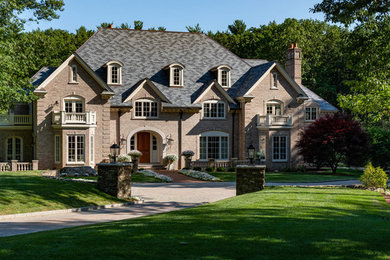 Huge traditional red three-story brick house exterior idea in Boston with a hip roof and a tile roof