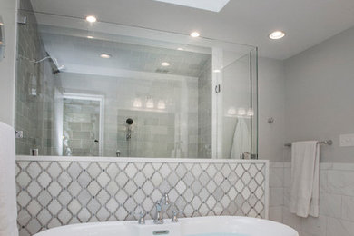 Photo of a traditional master bathroom in Dallas with raised-panel cabinets, white cabinets, a freestanding tub, green tile, ceramic tile, engineered quartz benchtops, white benchtops, a double shower, grey walls, ceramic floors, a drop-in sink, white floor and a hinged shower door.
