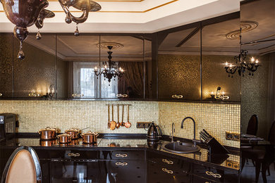 Traditional kitchen in Saint Petersburg with a drop-in sink, flat-panel cabinets, black cabinets, mosaic tile splashback, grey floor and black benchtop.