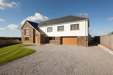 This is an example of a medium sized and multi-coloured modern two floor detached house in Cornwall with mixed cladding, a pitched roof and a tiled roof.
