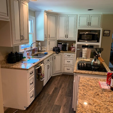 refaced cabinets------antique white w black glaze and new flooring