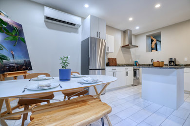 Kitchen/dining room combo - large contemporary ceramic tile and white floor kitchen/dining room combo idea in New York with white walls