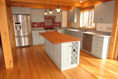 Inspiration for a traditional kitchen in Burlington with shaker cabinets and with island.