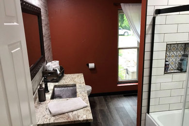 Inspiration for a mid-sized mediterranean master white tile and subway tile bathroom remodel in Cedar Rapids with flat-panel cabinets, dark wood cabinets, a two-piece toilet, orange walls, an undermount sink, quartz countertops and beige countertops