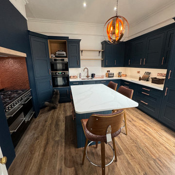 Copper T-Shaped Pull Handles in a Navy Blue Kitchen, USA