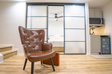 Inspiration for a small modern light wood floor and beige floor basement remodel in Atlanta with white walls