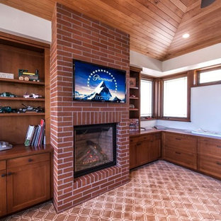 Large modern study in San Diego with a standard fireplace, a brick fireplace surround, white walls, carpet, a built-in desk and multi-coloured floors.