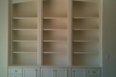 Mid-sized elegant living room library photo in Other with white walls