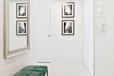 Photo of a mid-sized modern foyer in Gold Coast - Tweed with white walls, ceramic floors, a single front door, a white front door and white floor.