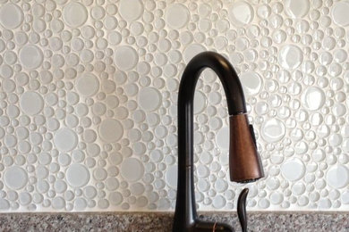 Kitchen photo in Chicago with granite countertops and white backsplash