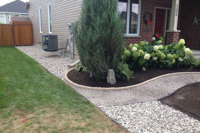 Design ideas for a large partial sun front yard stone garden path in Ottawa.
